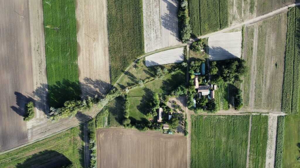 Aerial view of agricultural land beside a settlement