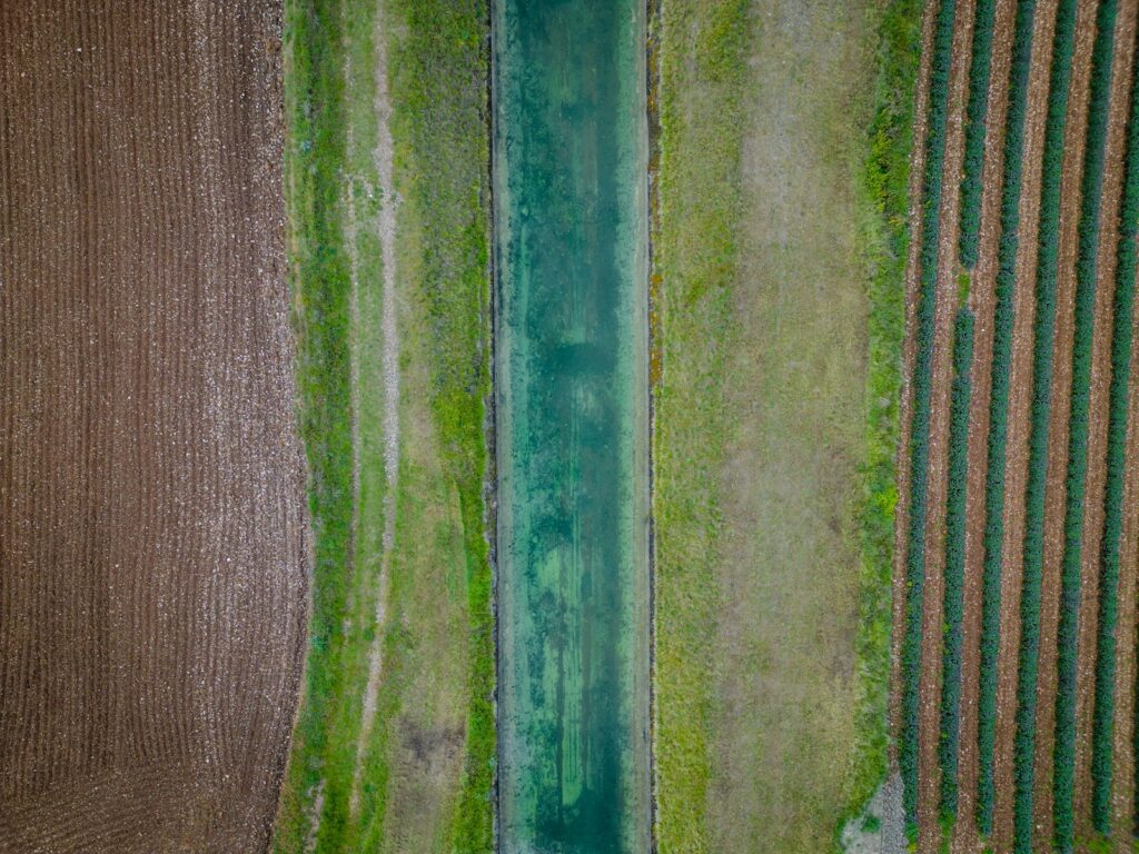 Aerial view of worked ground beside a watercourse