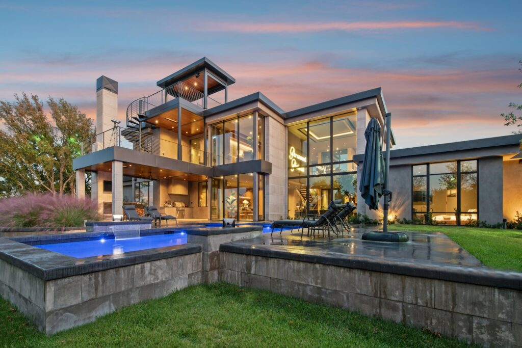 Modern luxury home with swimming pools at dusk, house for sale Malaysia