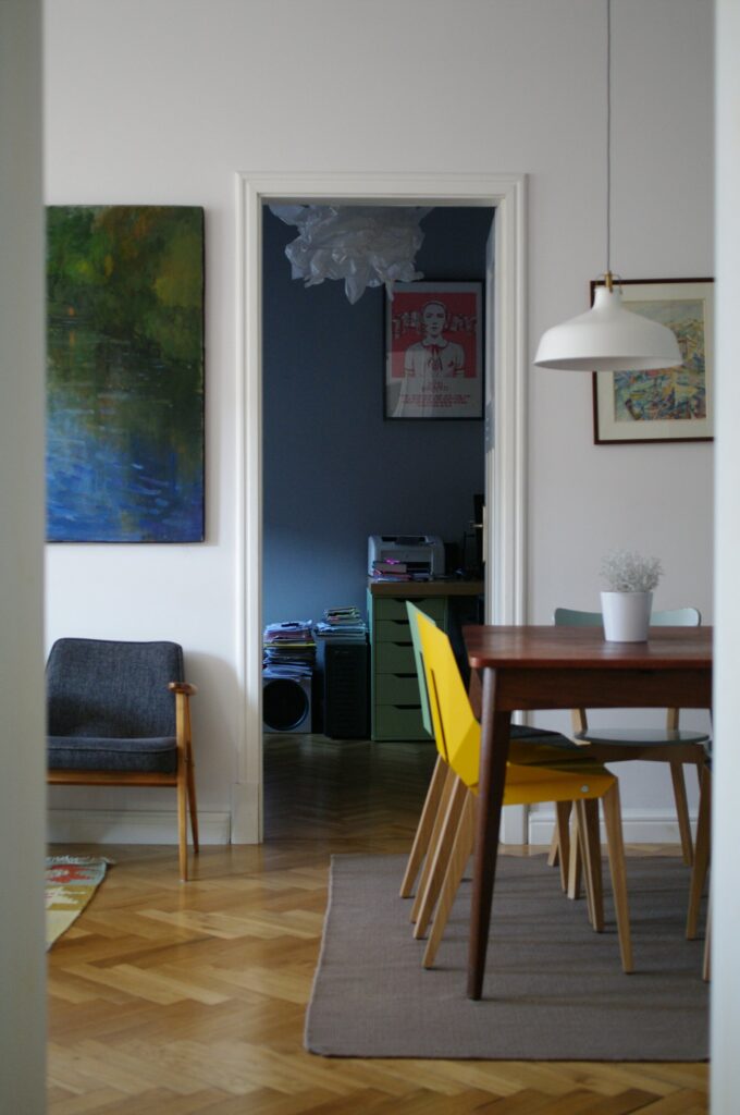Dining table and chairs beside a window