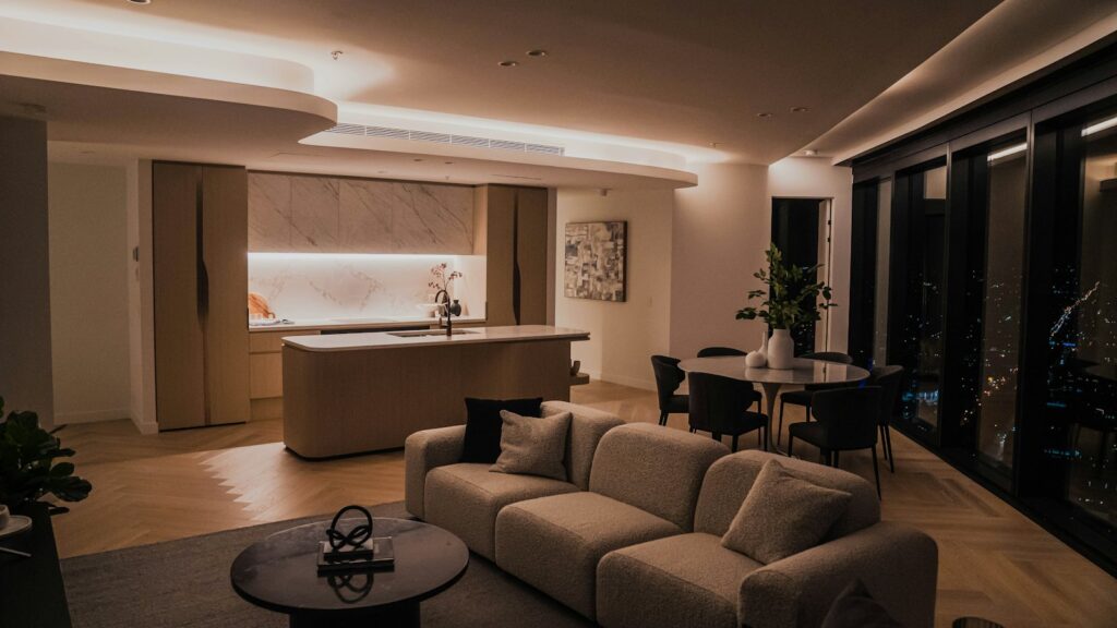 Open-plan living room and kitchen in a modern apartment, residential property for sale Malaysia