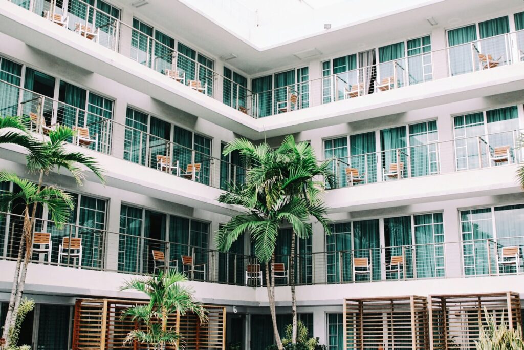 Hotel facade with balconies and palm courtyard