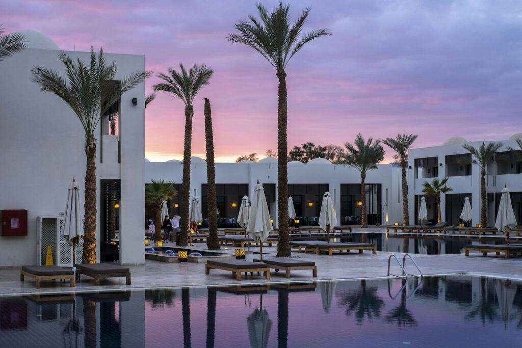 Resort swimming pool surrounded by palm trees
