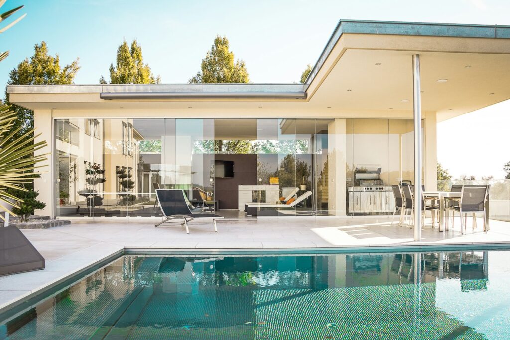 Glass-walled living space beside the pool